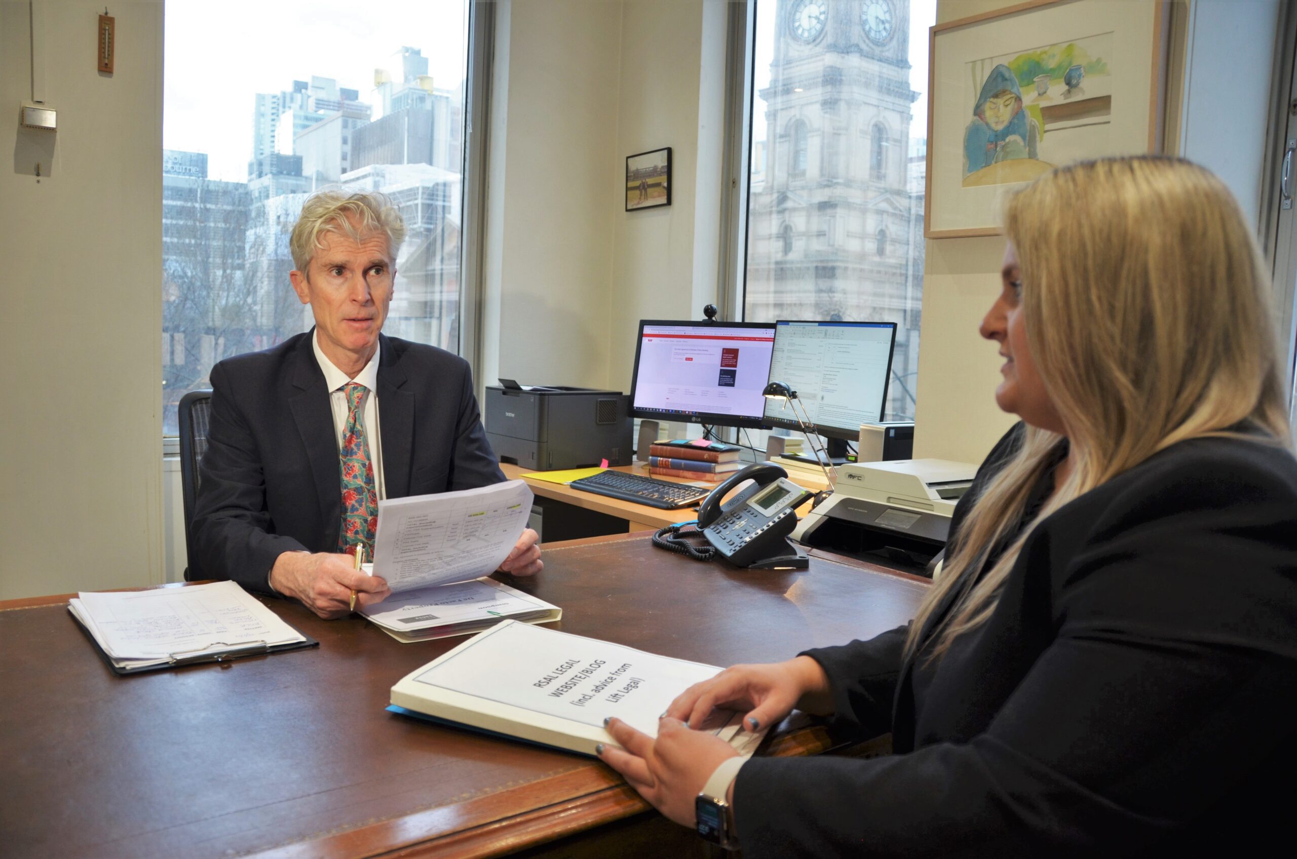 An image of two lawyers discussing in family law firms melbourne.